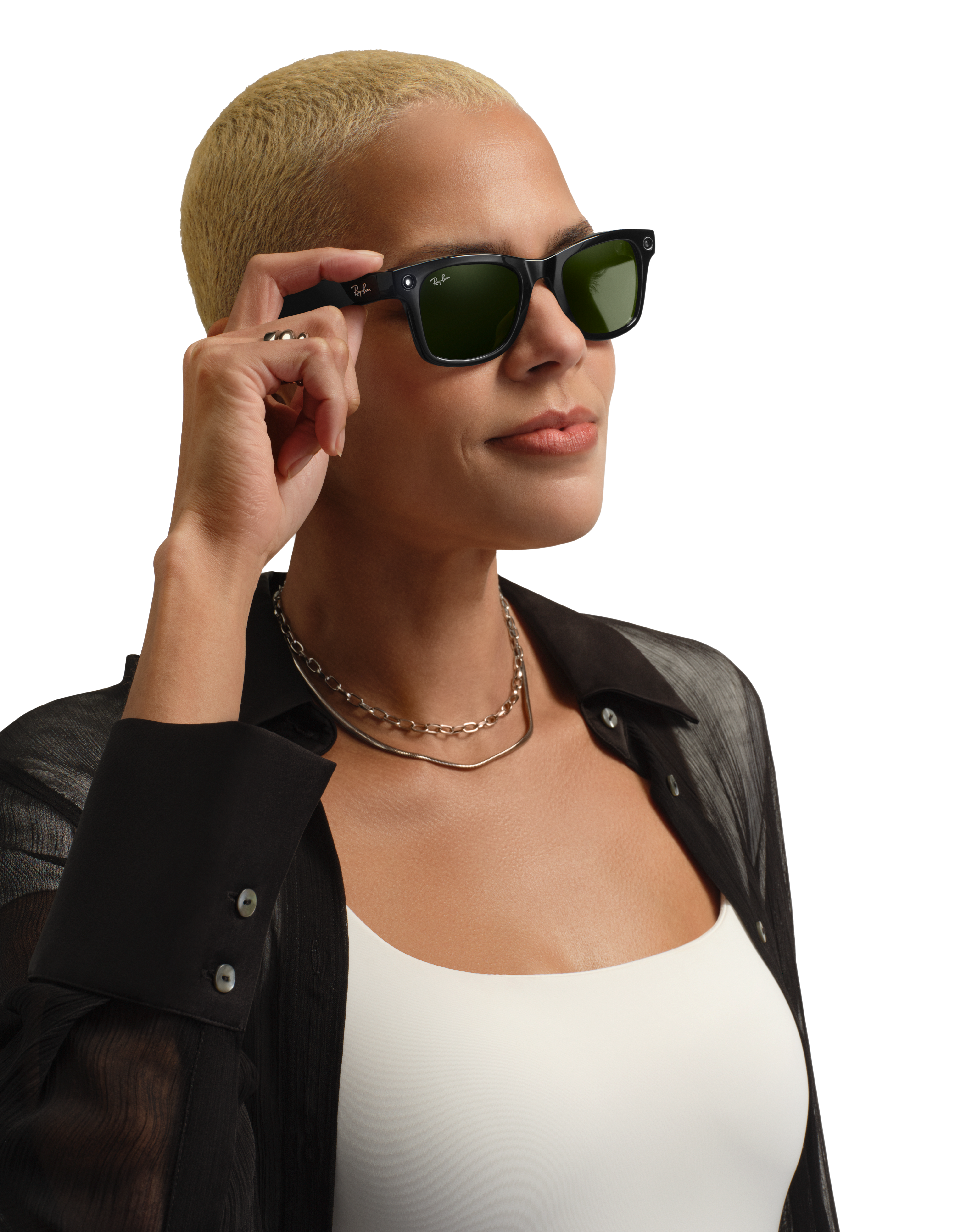 A person with short, bleached blonde hair wearing black Meta glasses with green lenses. The background is dark. Generated with Be My AI.