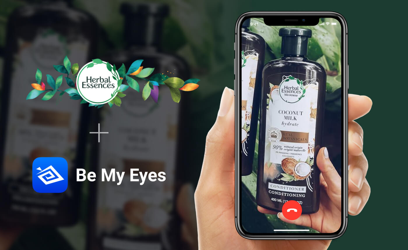 A smartphone screen displays a video call showcasing the Herbal Essences conditioner. In the background, the same product bottle and logos for Herbal Essences and Be My Eyes are prominently featured, highlighting their collaboration in a colorful display.