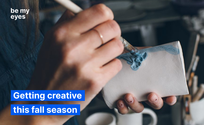 A person painting a white object with vibrant blue paint using a brush. Text reads, "Getting creative this fall season." Perfect for those looking to add a splash of color and creativity to their autumn.