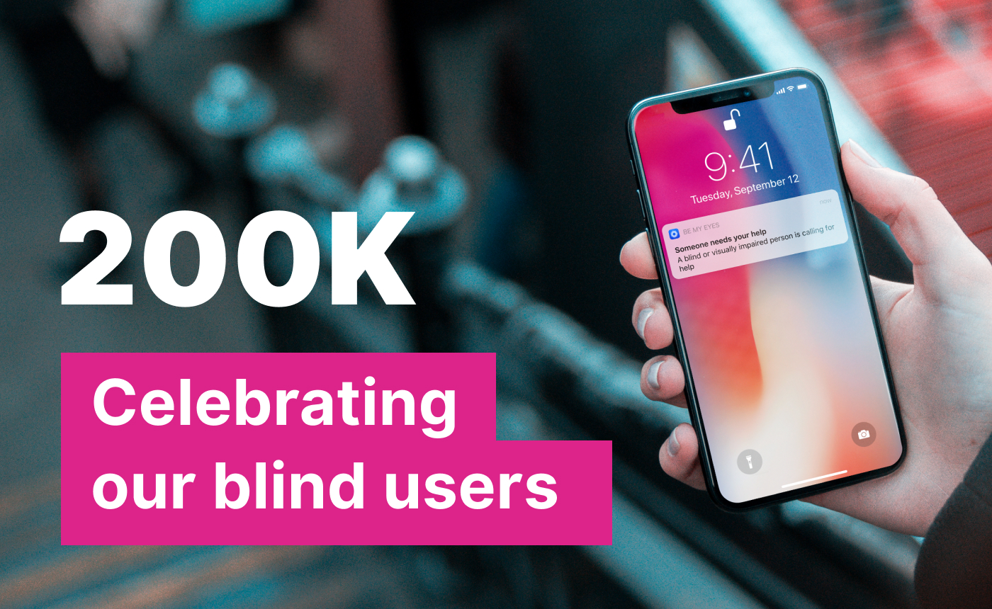 A hand holding a smartphone with a notification on the screen. Text overlay: "200K Celebrating our diverse users" in bold pink.