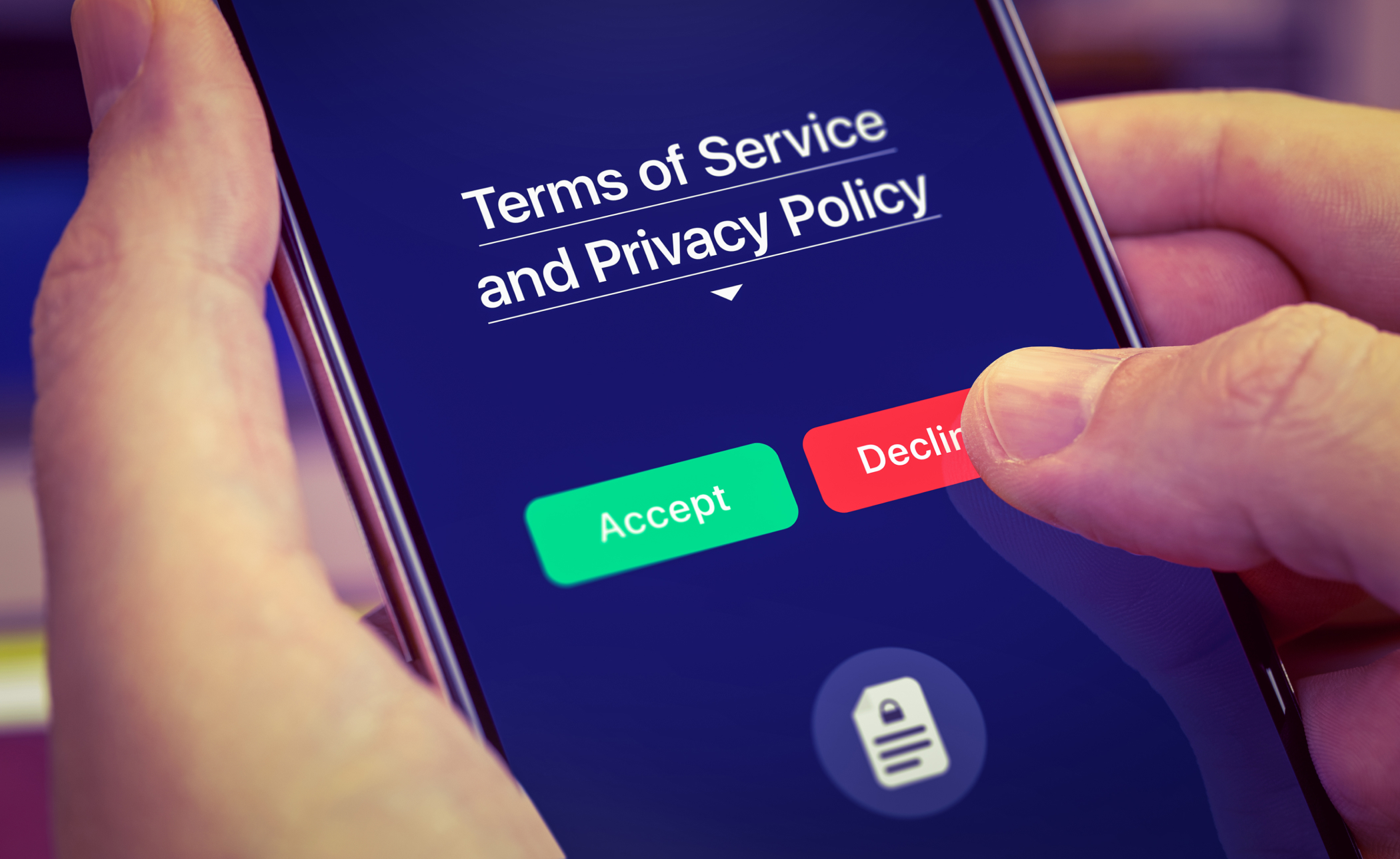 A person is using a smartphone showing "Terms of Service and Privacy Policy" with easy-to-spot green "Accept" and red "Decline" buttons.