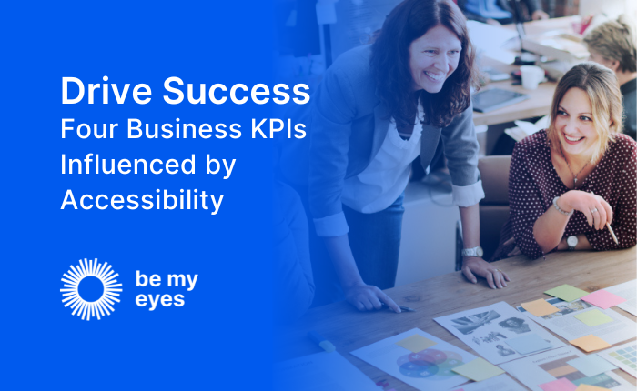 Two people smile and collaborate over documents at a desk. Text on the image reads: "Drive Success: Four Business KPIs Influenced by Accessibility." Logo: "be my eyes." Enhance teamwork and innovation using accessible solutions.