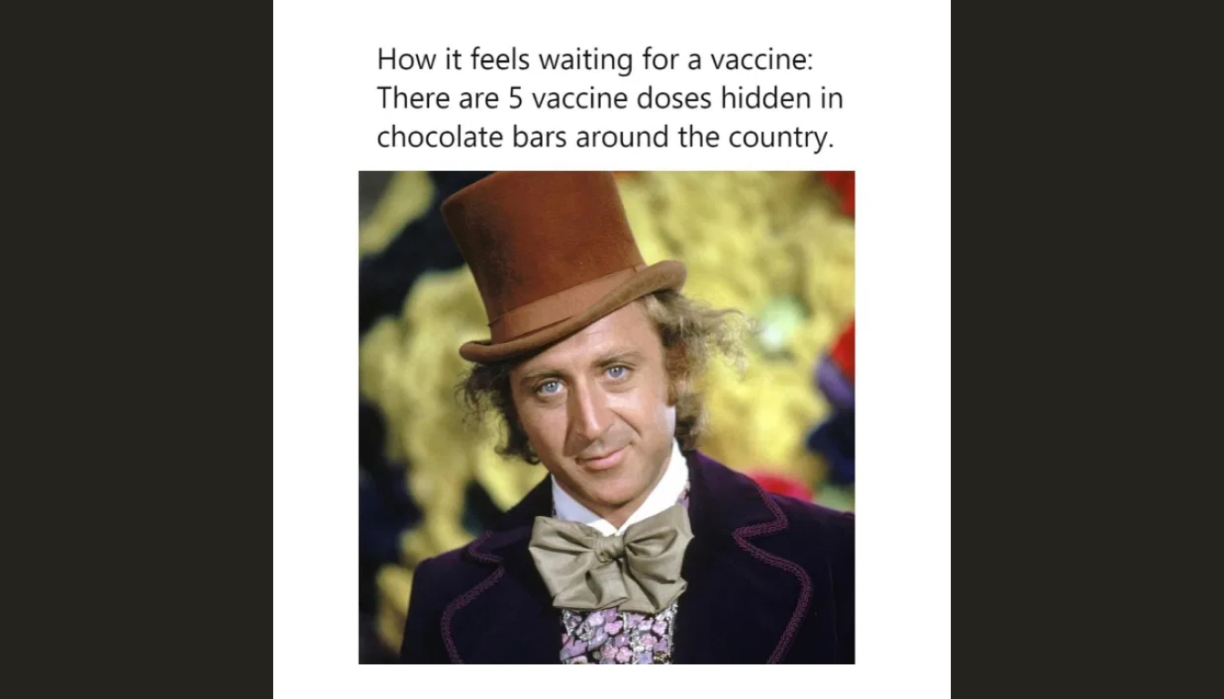 A person in a brown top hat and bow tie stands amusingly alongside text likening the wait for a vaccine to the quest for a coveted chocolate bar.
