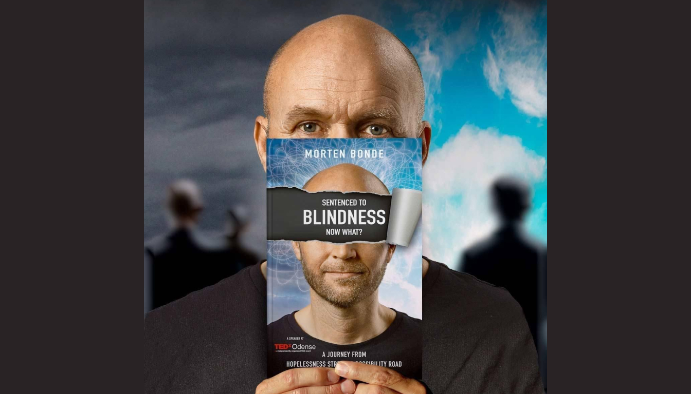 A person aligns the cover of "Sentenced to Blindness. Now What?" by Morten Bonde with their face against a backdrop of a cloudy sky, inviting curiosity about the journey within.