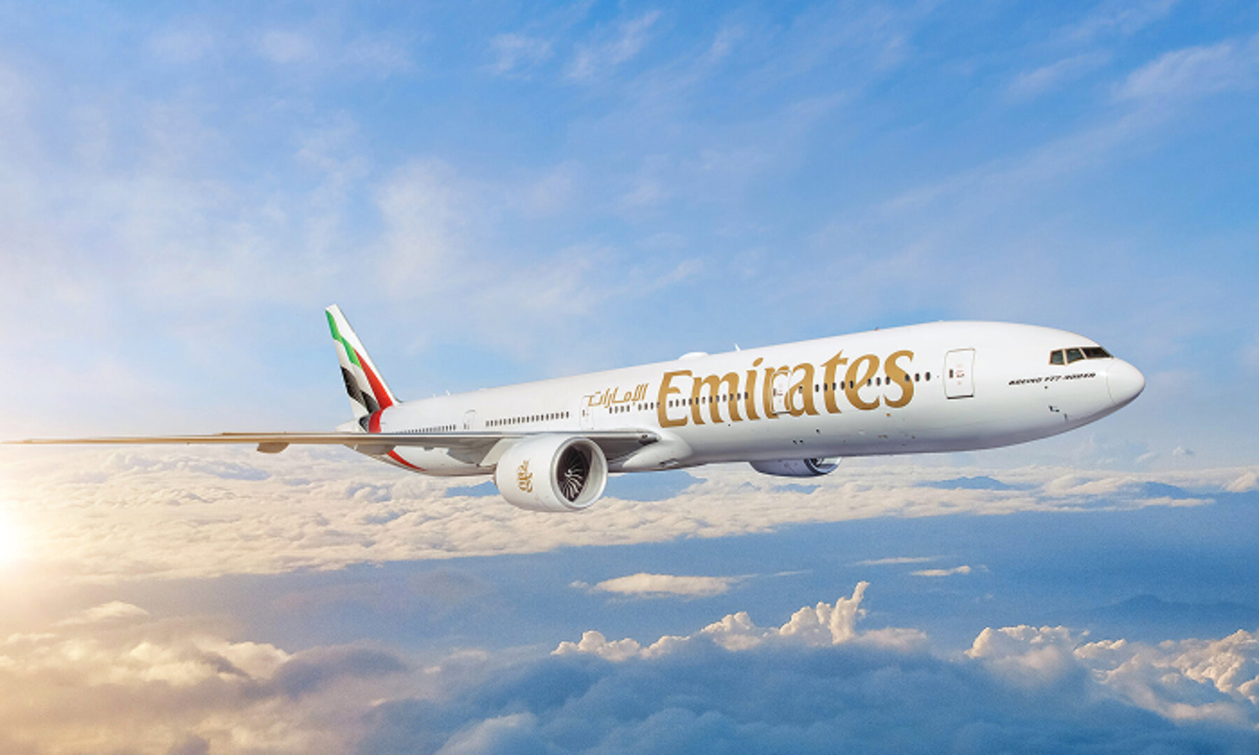 An Emirates airplane soars above clouds in a blue sky with sunlight in the background, captured perfectly for an accessible website.
